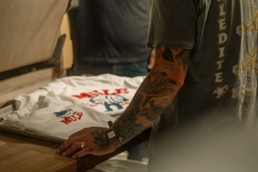 Close-up of a print being applied to a t-shirt in a workshop